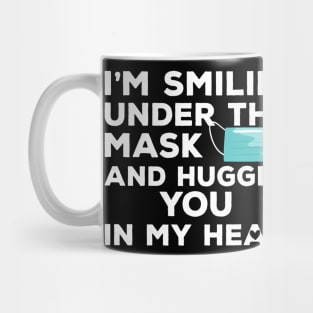 I'm Smiling under this Mask and Hugging you in my heart Mug